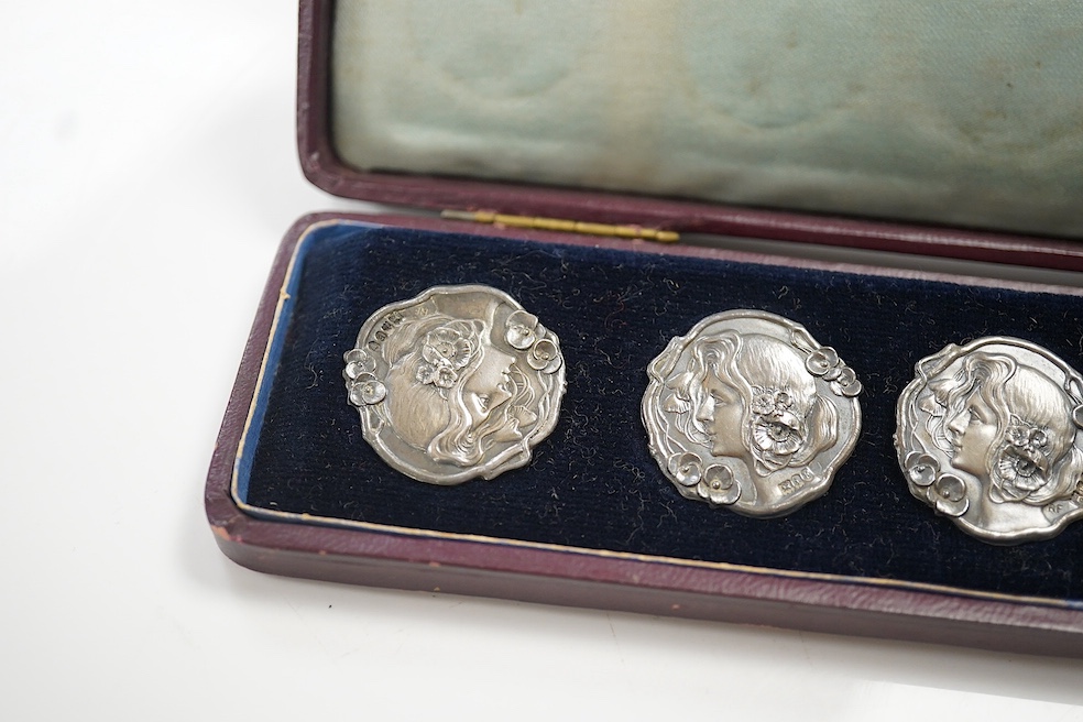 A cased set of six Edwardian Art Nouveau silver buttons, decorated with the head of a lady, import marks for Robert Friederich, London, 1902, 24mm. Condition - fair to good